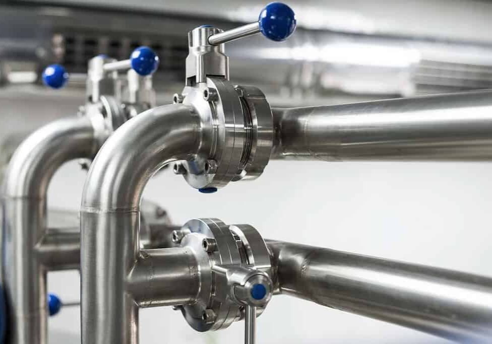 up close image of a system of steel pipelines with ball valves